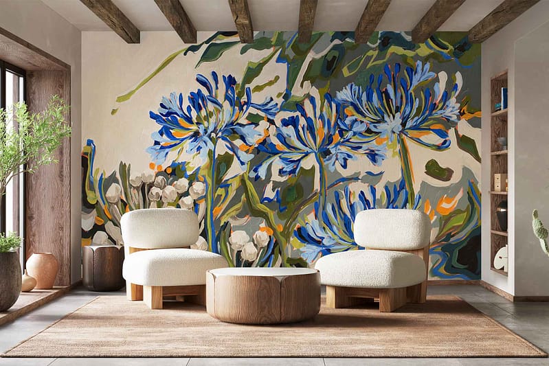 Large, vibrant floral mural wallpaper from the Saunter series featuring blue and green flowers, with bold botanical elements as the focal point.