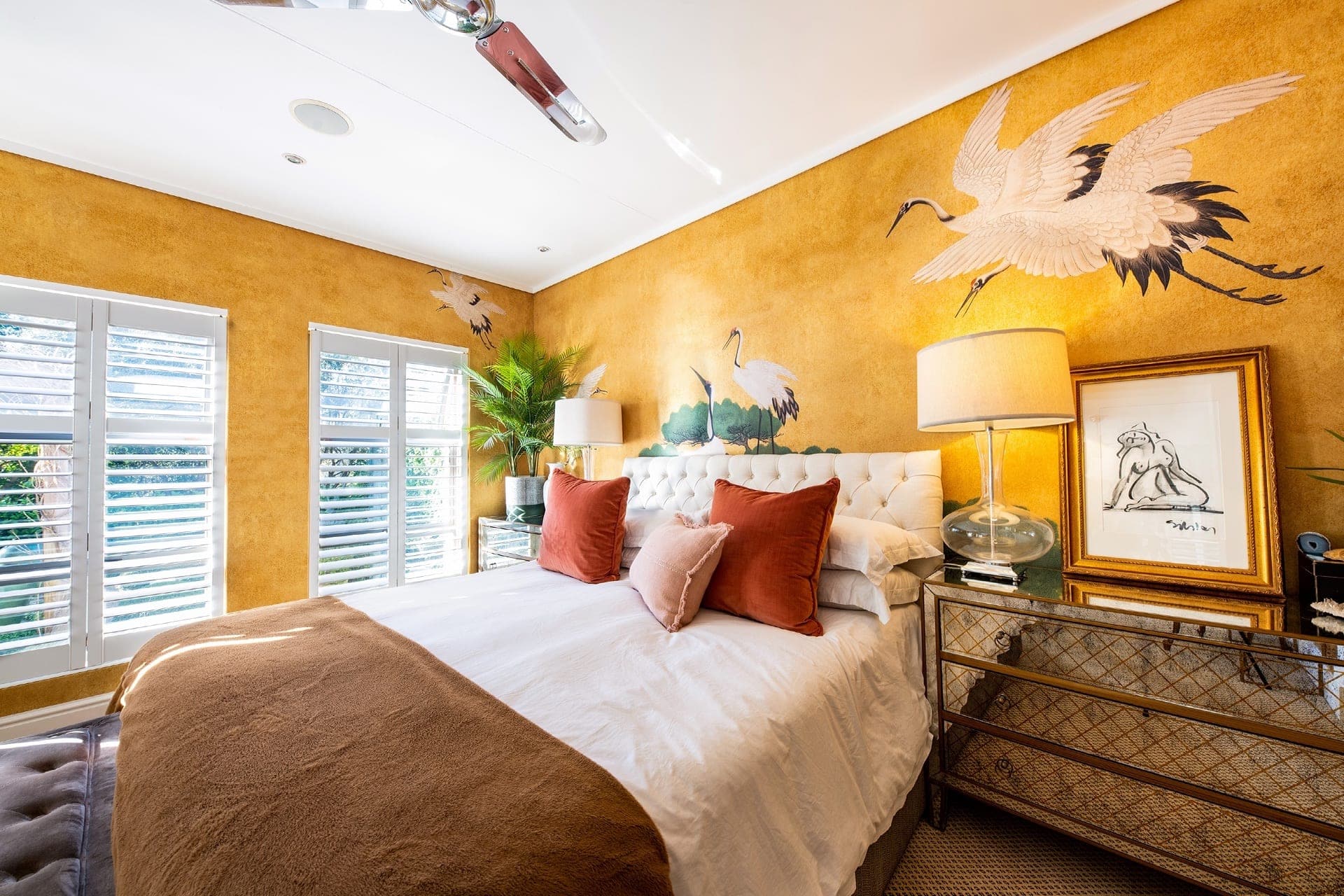 Yellow crane-themed wallpaper, featuring graceful cranes in shades of white and ivory with intricate feather detailing. The background is a warm, soft yellow with occasional touches of green foliage and delicate branches. The wallpaper's pattern includes subtle hints of gold accents, creating an elegant and serene ambiance.