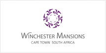 The Winchester Mansions wallpaper features a purple circular motif, elegant script reading "Winchester Mansions," accompanied by "Cape Town South Africa" in refined text. The design evokes a sense of inviting warmth and home-like essence, distinguished by its unique carousel theme. Key elements are the purple circular design and sophisticated typography.